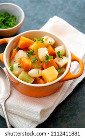 Roasted Or Baked Root Vegetables With Fresh Herbs, Orange Vegetables On Plate. Vegan Food