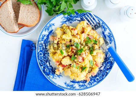 Roasted boiled potatoes with ham and eggs, top view