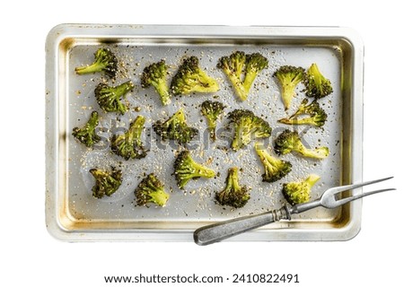 Roasted broccoli cabbage with garlic in baking tray. Isolated on white background, top view