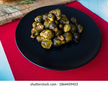 Roasted Brussel Sprout On A White Tablecloth And Red Table Runner