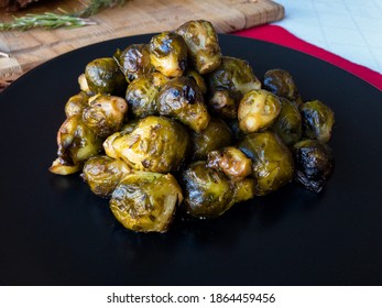 Roasted Brussel Sprout On A White Tablecloth And Red Table Runner, Close Up