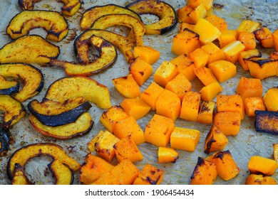 Roasted Butternut Squash Cubes And Acorn Squash Slices On Parchment Paper On A Baking Sheet