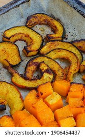 Roasted Butternut Squash Cubes And Acorn Squash Slices On Parchment Paper On A Baking Sheet