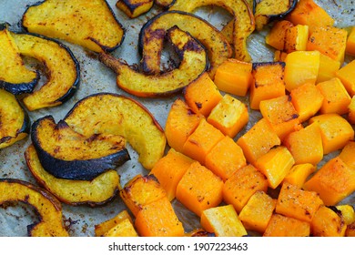 Roasted Butternut Squash Cubes And Acorn Squash Slices On Parchment Paper On A Baking Sheet