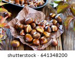 Roasted chestnuts on an old board. Selective focus.