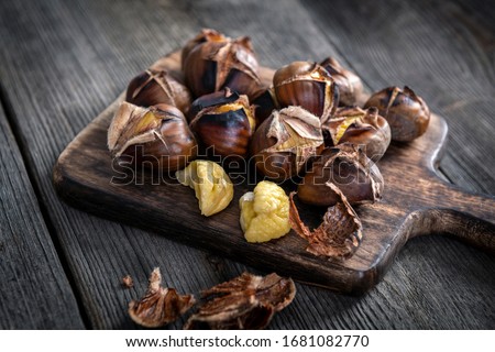 Roasted chestnuts on wooden background