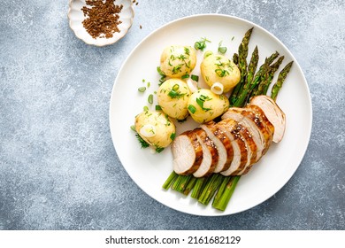 Roasted chicken breast, boiled new potato and grilled asparagus - Powered by Shutterstock