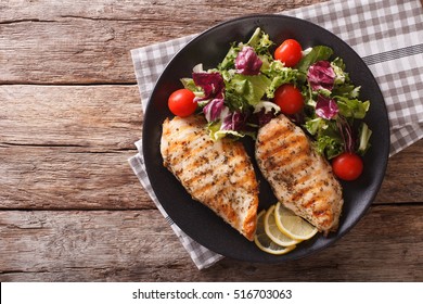 roasted Chicken breast with mix salad of chicory, tomatoes and lettuce on a plate close-up. horizontal view from above
 - Powered by Shutterstock