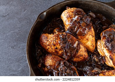 Roasted Chicken Breast With Red Onion Sauce In A Cast Iron Pan