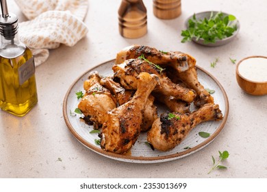 Roasted chicken drumsticks with garlic and herbs served with ranch