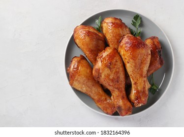 Roasted Chicken Drumsticks In Honey And Soy Sauce On Grey Plate, Top View. Space For Text.