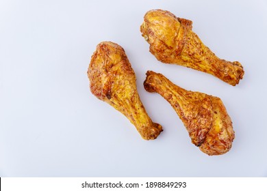 Roasted chicken drumsticks marinated with buffalo sauce isolated on white background. Top view.