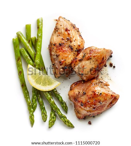 roasted chicken meat and grilled asparagus isolated on white background, top view