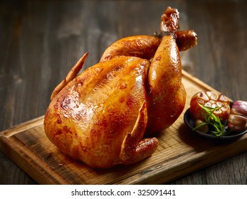 roasted chicken on wooden cutting board