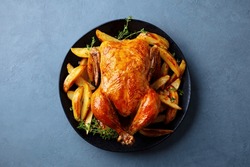 Roasted Chicken With Potatoes On Dark Plate. Grey Background. Close Up. Top View.