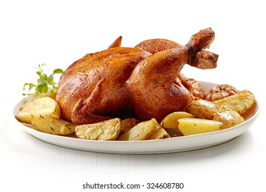 roasted chicken and potatoes on white plate