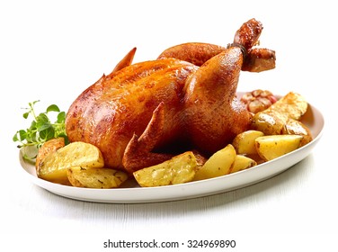 roasted chicken and potatoes on white plate