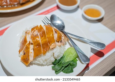 Roasted Chicken With Rice On Wooden Table. HongKong Cuisine, Chinese Cuisine. South East Asian Style Chicken Rice Set Steamed Roasted Sliced Chicken