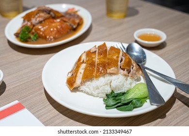 Roasted Chicken With Rice On Wooden Table. HongKong Cuisine, Chinese Cuisine. South East Asian Style Chicken Rice Set Steamed Roasted Sliced Chicken
