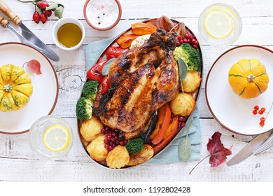 Roasted Chicken Or Turkey With Vegtables And Herbs On A Rustic Wooden Table. Thanksgiving Day Food. Festive Family Dinner Table. 