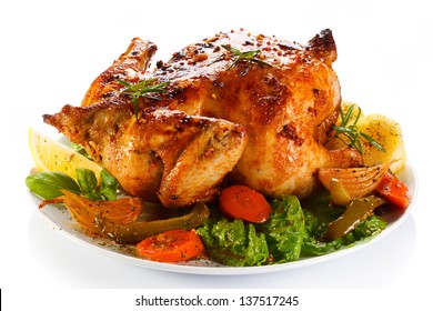Roasted chicken and vegetables on white background