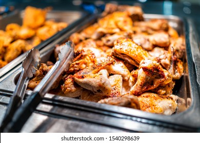 Roasted Chicken Wings Buffet Bar Self Serve With Tongs In Grocery Store, Restaurant Or Catering Event With Crisp Skin And Unhealthy Food