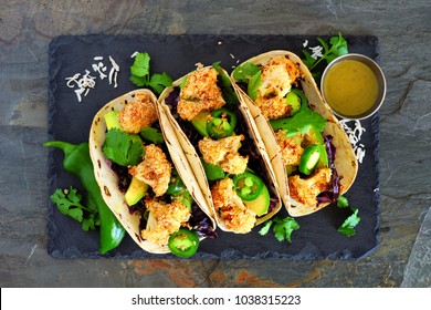 Roasted Coconut Cauliflower Tacos. Healthy, Vegan Meal. Above View On A Dark Slate Stone Background.