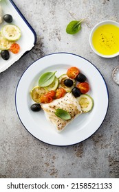 Roasted cod with olives and tomatoes