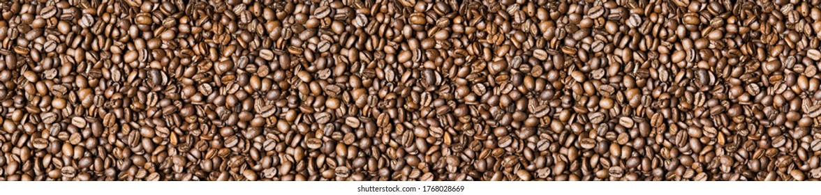 Roasted coffee beans background - full frame detail. Close up of a brown surface texture of aroma black caffeine drink ingredient for coffee beverage. Wide format banner.