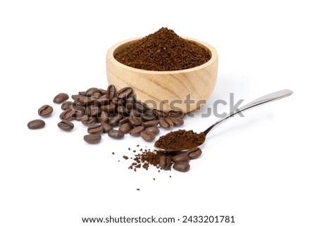 Roasted coffee beans with coffe powder (ground coffee) in wooden bowl and spoon isolated on white background. 