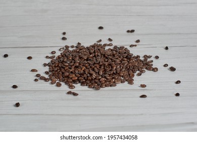 Roasted coffee beans falling and piling up