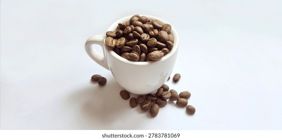  Roasted coffee beans filled inside a white demitasse cup on a clean white background.
