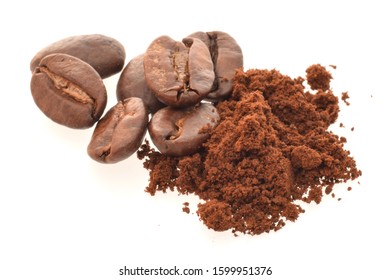 Roasted coffee beans with fragrant powder isolated on white