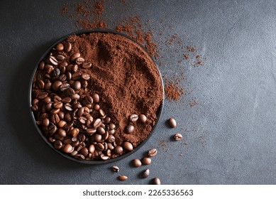 Roasted coffee beans and ground coffee on  gray background.  Copy space. Directly above.  