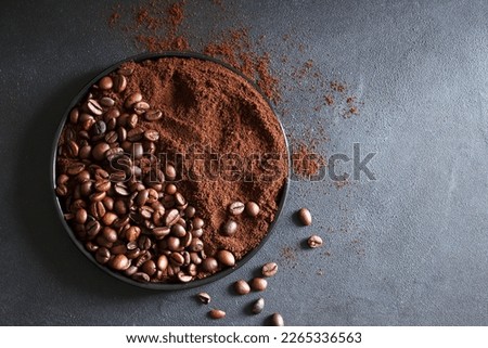 Roasted coffee beans and ground coffee on  gray background.  Copy space. Directly above.  