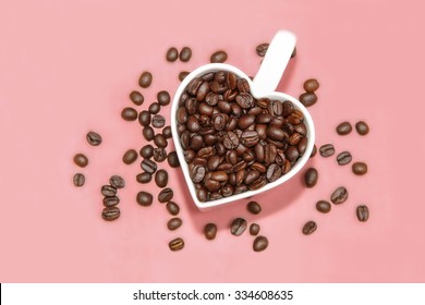 Roasted Coffee Beans In Heart Shape Cup.