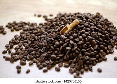 Roasted coffee beans on rustic wooden table background