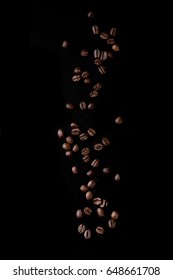 Roasted Coffee Beans Over Black Background. Isolated