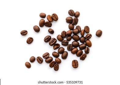 Roasted coffee beans pile from top on white background - Shutterstock ID 535109731