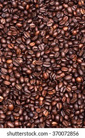 Roasted coffee beans scattered on the plane as a uniform background. - Shutterstock ID 370072856