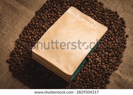 Roasted coffee beans scattered on burlap fabric provide a warm backdrop for a customizable kraft paper stand-up pouch, perfect for presenting coffee product designs