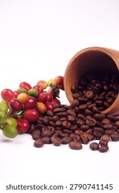 Roasted coffee beans spilling from a rustic wooden cup alongside a branch of ripe coffee cherries, illustrating the complete journey from coffee harvest to premium roasted coffee.