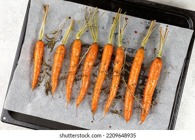 Roasted Cooked Baked Carrots On Baking Tray, Top View, Overhead. Healthy Vegan Food.