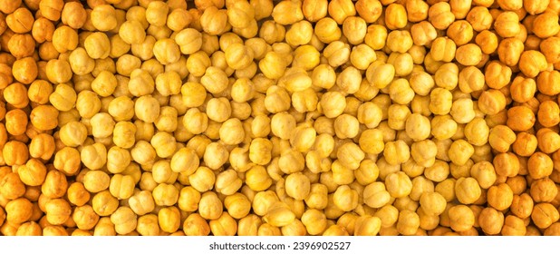 Roasted Crispy Chickpeas Texture Background, Fried, Salty Chana Snack, Legume Pattern, Yellow Beans Mockup with Copy Space for Text Top View
