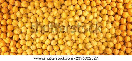 Roasted Crispy Chickpeas Texture Background, Fried, Salty Chana Snack, Legume Pattern, Yellow Beans Mockup with Copy Space for Text Top View