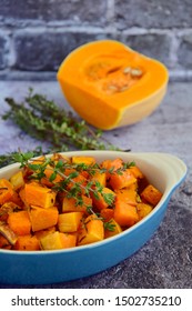 Roasted Cubed Butternut Squash With Thyme On Grey Background