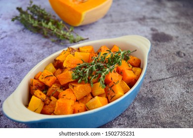 Roasted Cubed Butternut Squash With Thyme On Grey Background