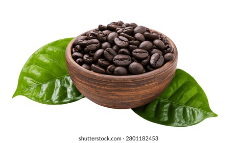 Roasted dark coffee beans in a rustic wooden bowl with fresh green leaves