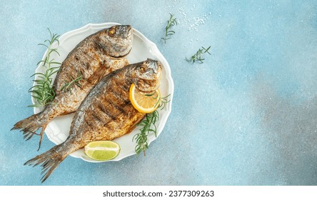 roasted dorado or sea bream fish with lemon, organic healthy products. Detox and clean diet concept. place for text, top view,