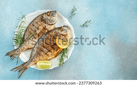roasted dorado or sea bream fish with lemon, organic healthy products. Detox and clean diet concept. place for text, top view,